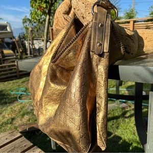 GUCCI oversized horsebit hobo shoulder bag with Gucci logo embossed gold leather